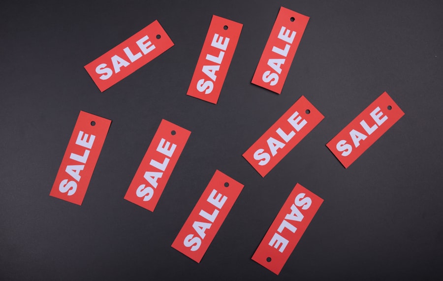 Scattered red SALE tags on a dark surface